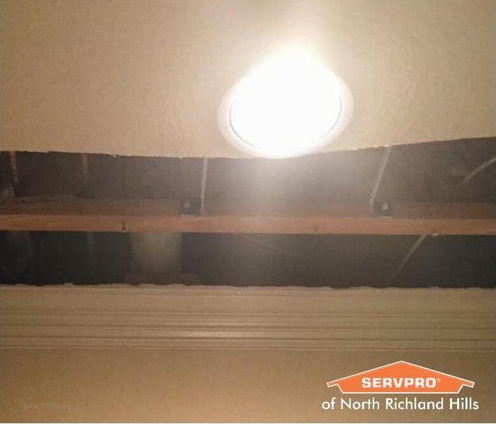 damaged ceiling next to a light